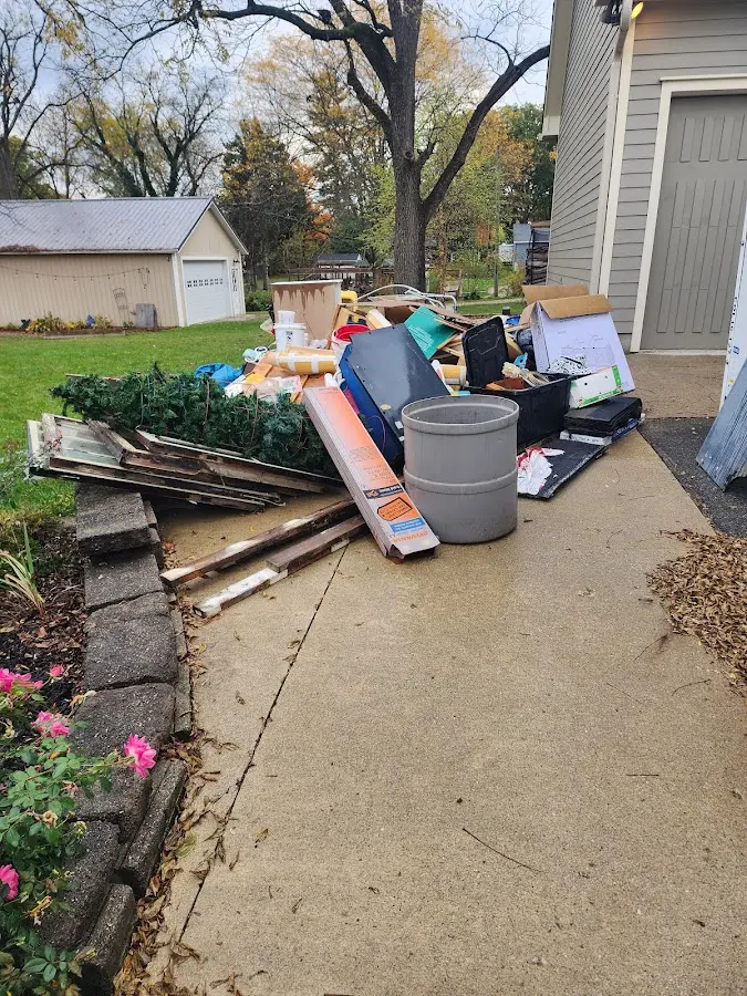 Dumpster being loaded with debris for Roofing Dumpster Rental in Bridgeport
